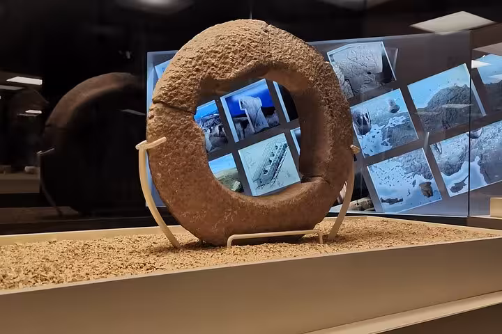 Ancient stone ring artifact at Şanlıurfa Archaeology Museum, featured on private Göbeklitepe tour from Istanbul