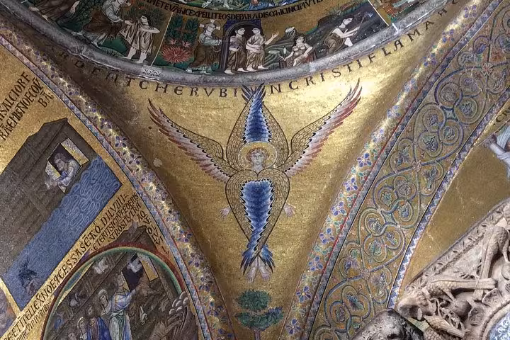 Exquisite gold and blue mosaic depicting an angel in the Golden Basilica, showcasing Byzantine art and craftsmanship.