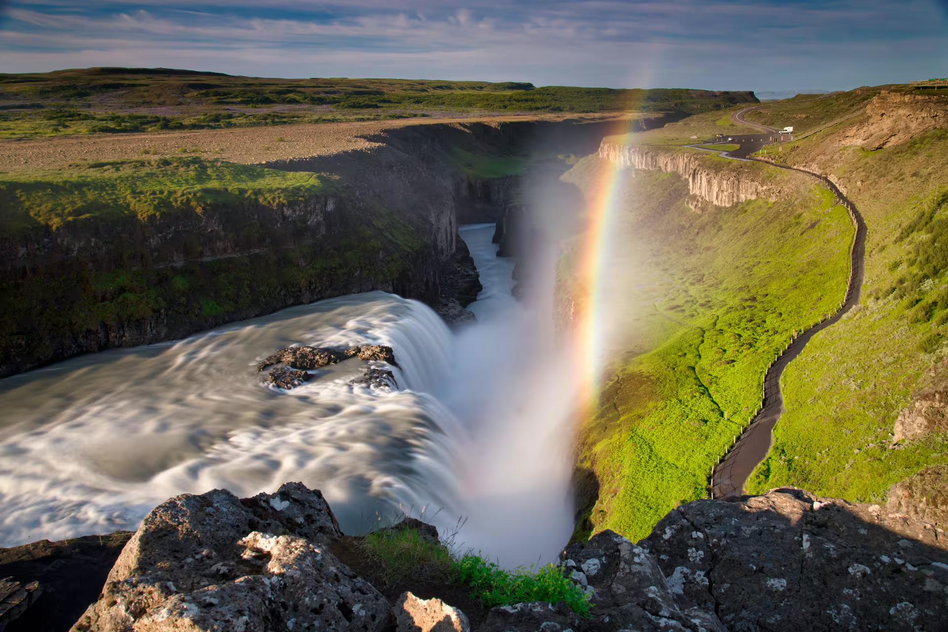 A picture of a waterfall that formed a rainbow in the centre.