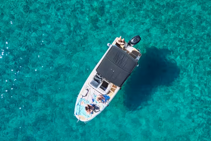 Aerial view of private boat on turquoise sea, Golden Horn Beach and Hvar Island North Shore cruise