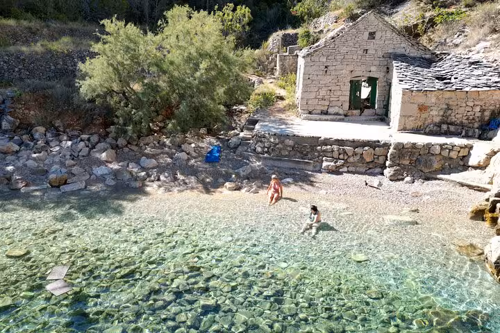 Secluded pebble cove with crystal-clear water on Hvar north shore, stop on Golden Horn private boat tour
