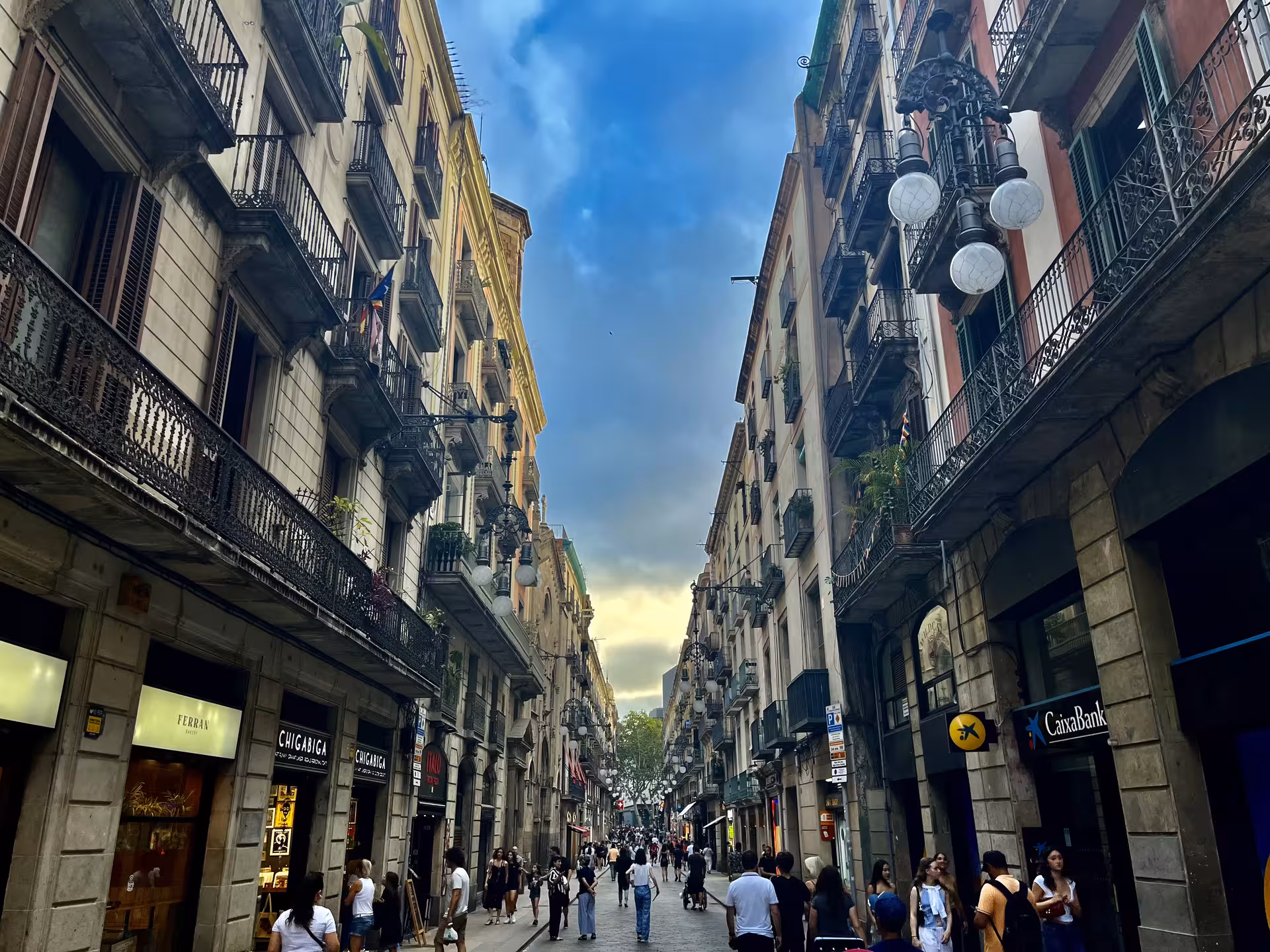 Gothic Quarter Barcelona street scene on Misterios Locales tour, historic balconies and lively crowd