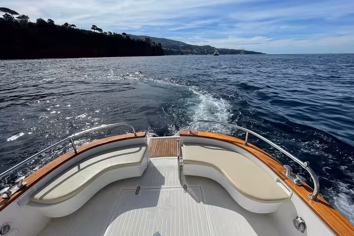 View from the deck of a typical Gozzo 750 boat navigating the serene waters on a Sorrento to Positano tour.