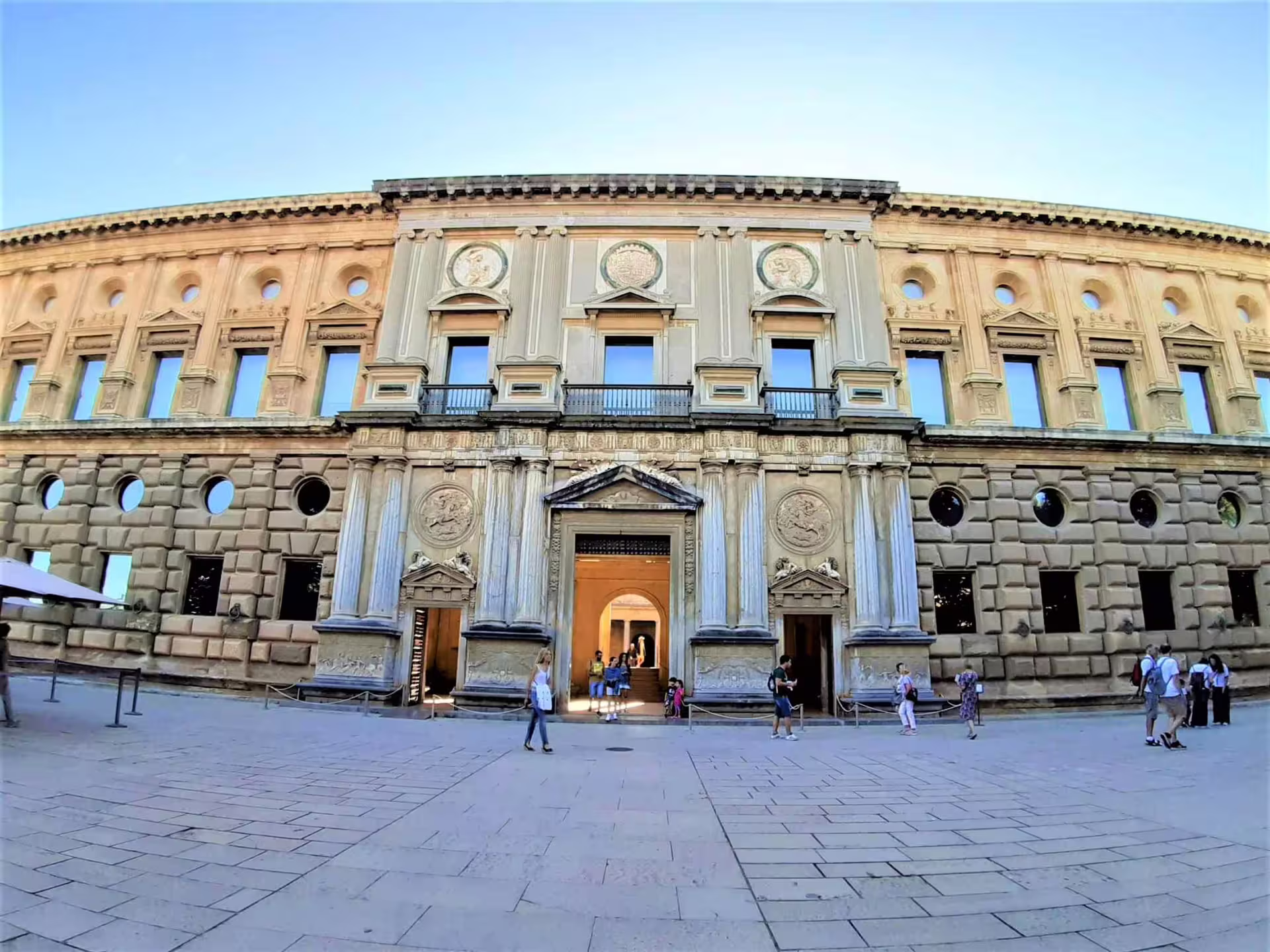 Granada city tour stop at Charles V Palace facade, part of private Alhambra trip with hotel pick-up