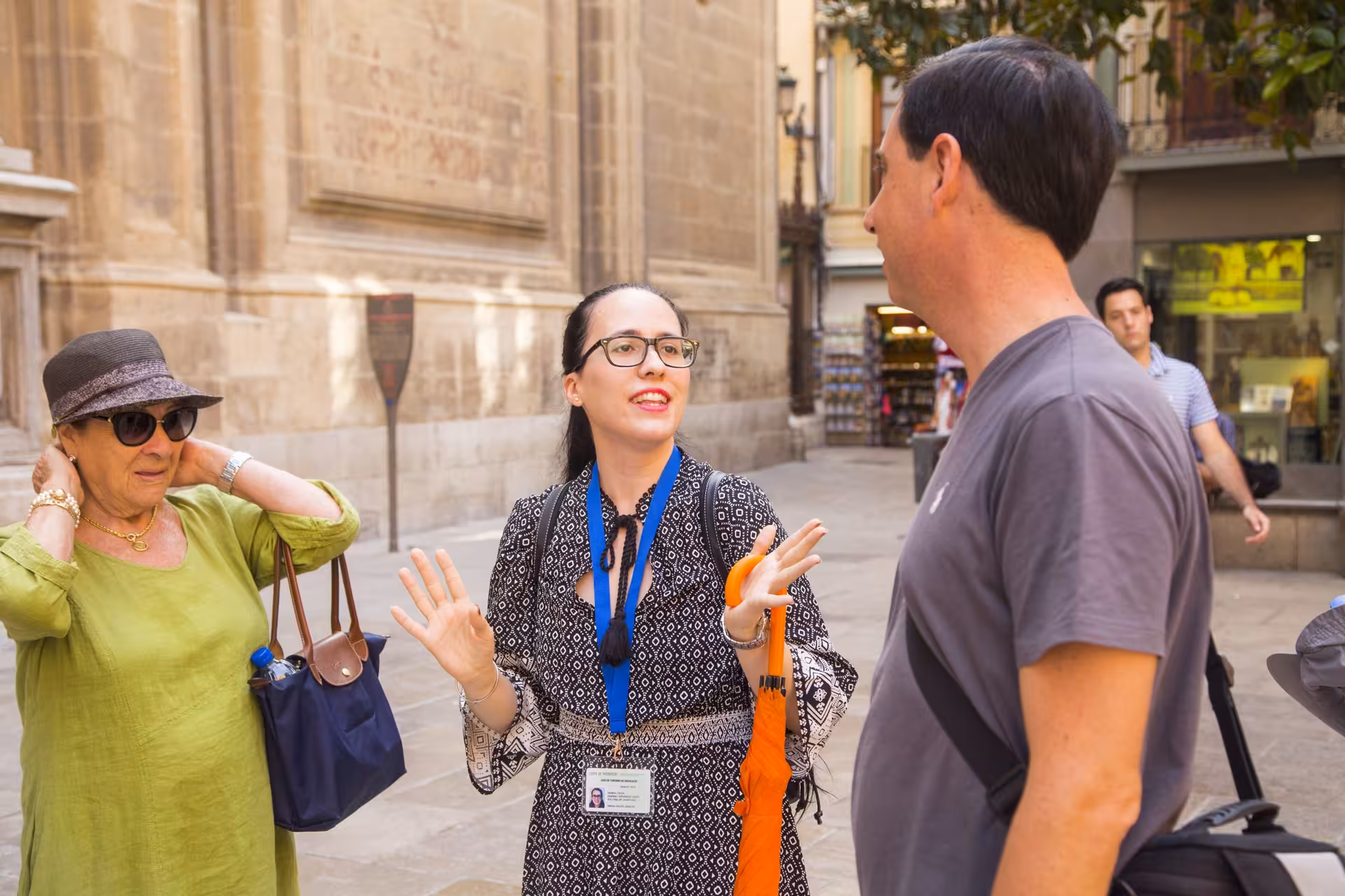 Tour guide engaging visitors outside Granada's historic Cathedral on a guided city tour.