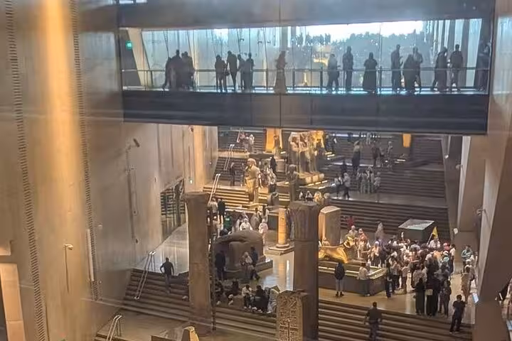 Crowds exploring the Grand Egyptian Museum atrium galleries in Cairo with tickets included on half-day tour