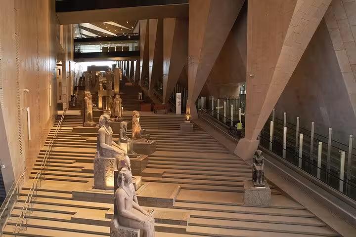 Grand Egyptian Museum Cairo grand staircase with ancient statues on a private tour with guide