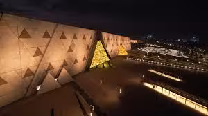 Grand Egyptian Museum exterior at night near Giza Pyramids, all-inclusive private tour with hotel pickup