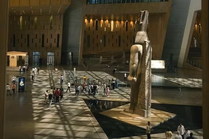 Grand Egyptian Museum atrium with towering pharaoh statue, part of Giza Pyramids and Sphinx day tour