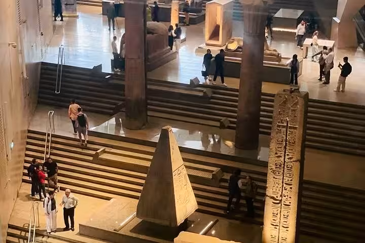 Grand Egyptian Museum atrium with ancient obelisks and statues, included in Giza Pyramids Sphinx lunch tour