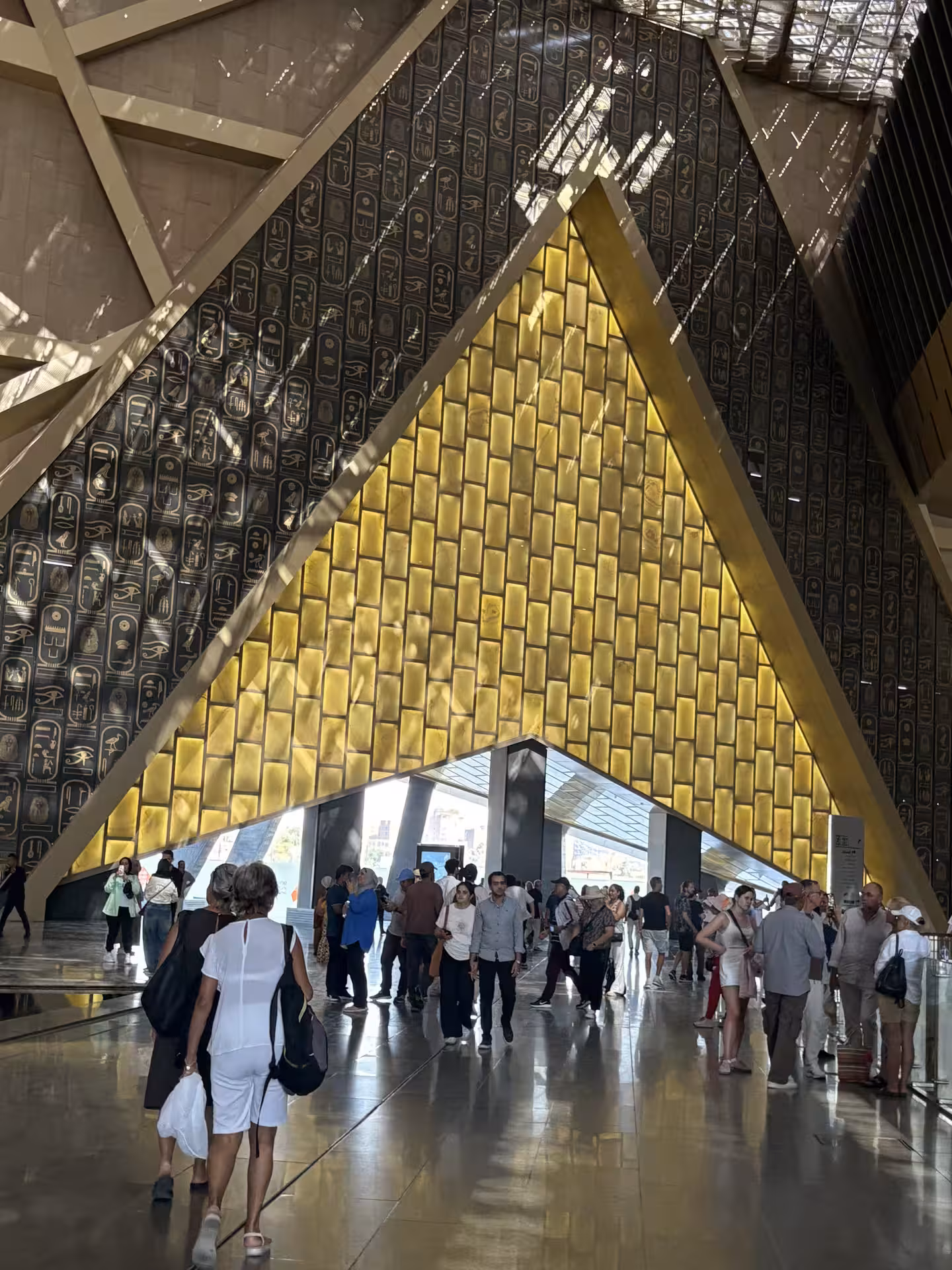 Golden staircase and hieroglyph walls inside the Grand Egyptian Museum, Cairo, on private guided tour