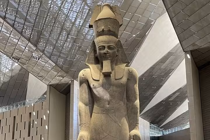 Colossal pharaoh statue inside the Grand Egyptian Museum Giza, highlight of pyramids and Sphinx tour with lunch