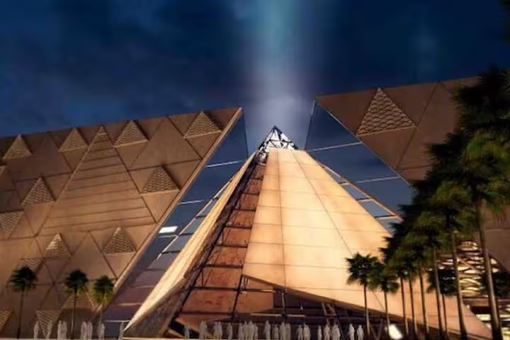 Grand Egyptian Museum pyramid-shaped facade at night, key stop on From Port Said Giza Pyramids tour