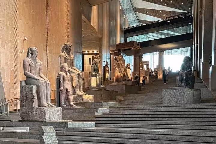 Grand Egyptian Museum grand staircase with monumental statues, included on half-day tour with lunch and entry tickets