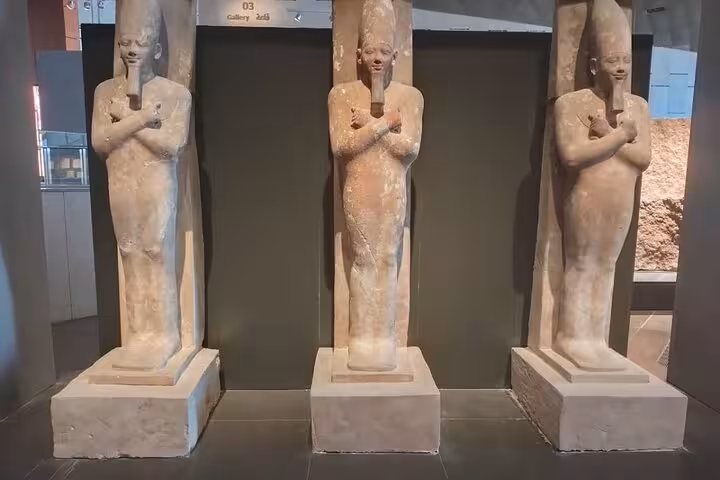 Ancient Egyptian standing statues on display at Grand Egyptian Museum Cairo on private guided tour