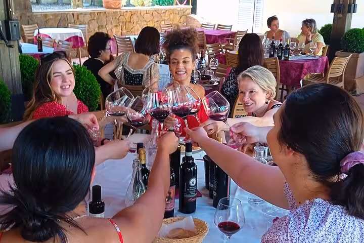 Tour participants enjoying a wine tasting at a Tuscany winery near San Gimignano.