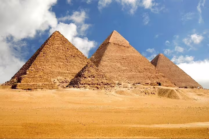 Wide view of the Great Pyramids of Giza in Cairo desert, featured on Hurghada to Cairo day trip by bus with guide