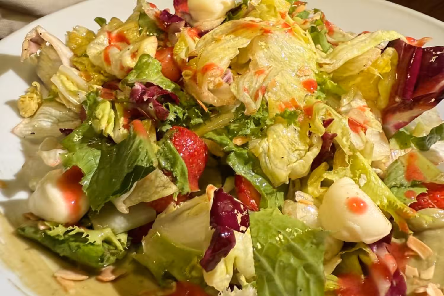 Fresh Greek salad with greens, strawberries and creamy cheese at Santo Winery dinner in Santorini