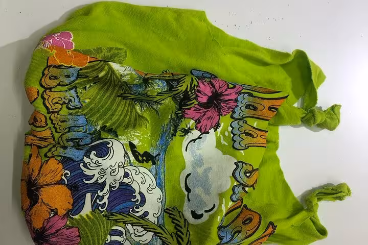 Bright green upcycled T-shirt tote bag with knotted handles, handmade reusable bag from textile workshop