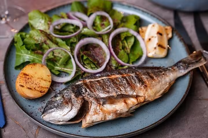 Grilled sea bass with salad served during Istanbul Bosphorus New Year’s Eve dinner cruise