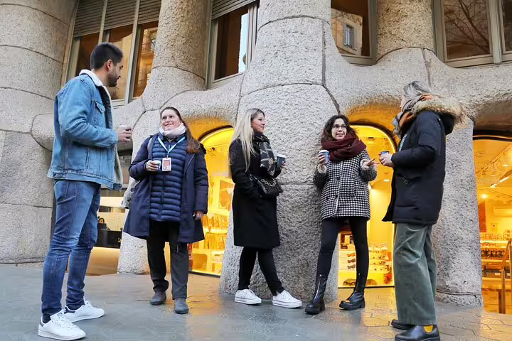 Small group with guide chatting outside La Pedrera before a guided morning tour of Gaudí’s Barcelona and Casa Batlló option