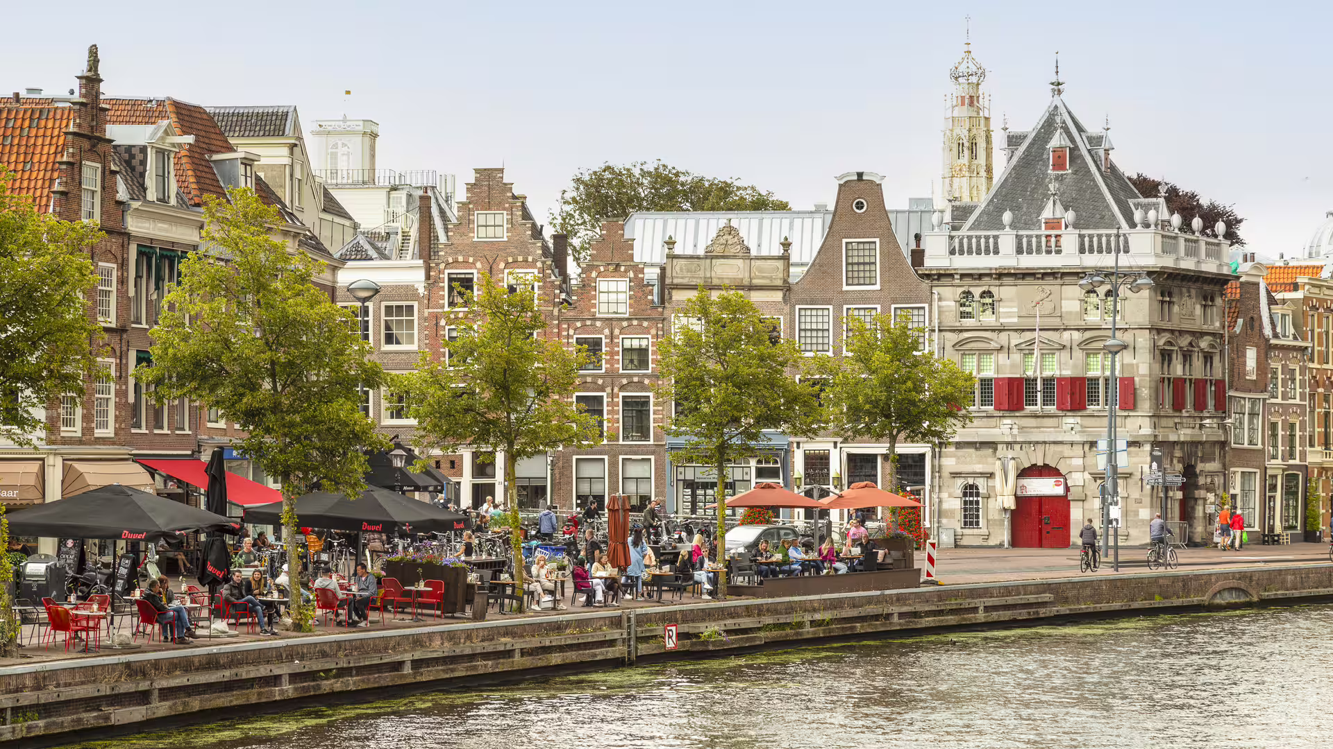 Haarlem canal-side cafes and historic Dutch gabled houses on a self-guided walking tour audioguide