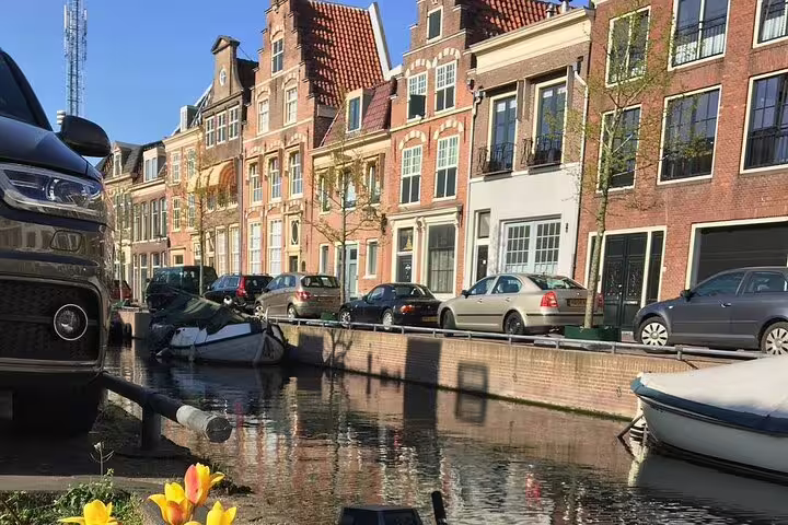 Haarlem canal lined with historic Dutch houses and boats, scenic moment on an old town private walk