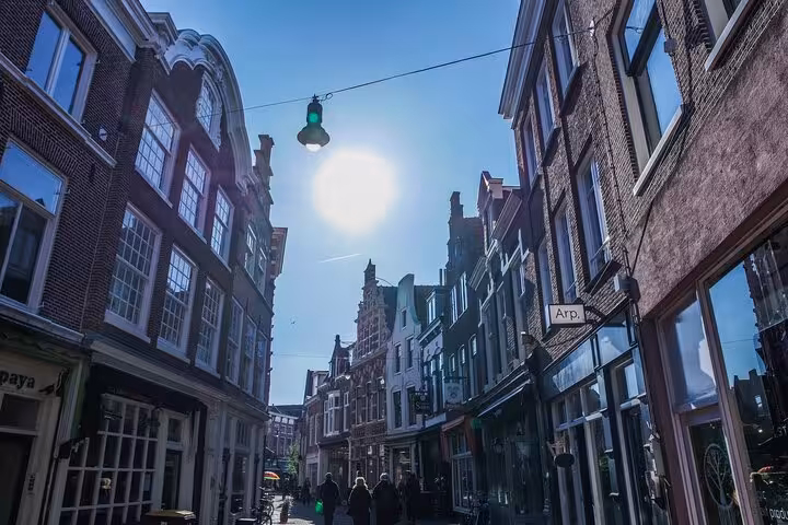 Sunny Haarlem old town shopping street with gabled houses, ideal stop on a 2-hour private walking tour