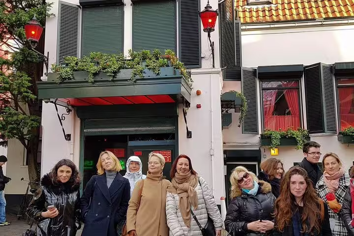 Small group on Haarlem Old Town private walking tour outside a historic Dutch house with shutters and lanterns