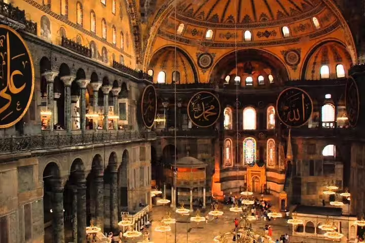 Inside Hagia Sophia with grand dome and calligraphy, featured on a private Istanbul highlights bazaar tour