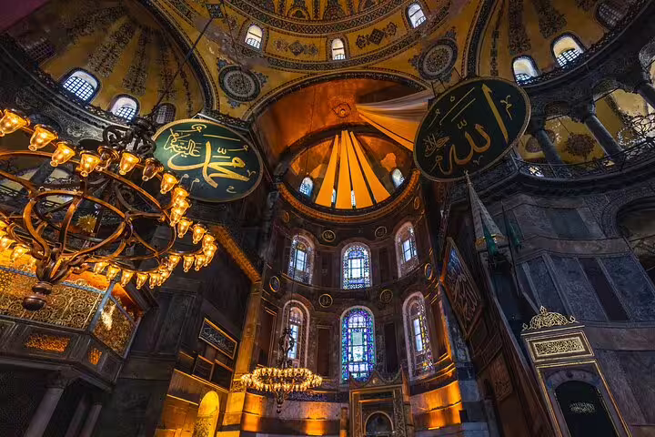 Intricate interior of Hagia Sophia showcasing ornate chandeliers and historic Islamic art in Istanbul.