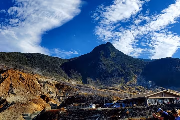 Scenic view of Hakone's volcanic landscapes under a bright blue sky, ideal for Mt. Fuji & Hakone private tours.