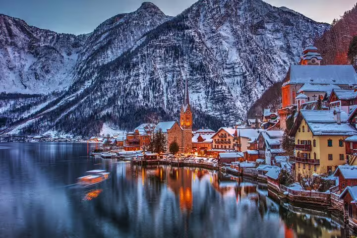 Winter dusk view of Hallstatt lake and church spire, scenic highlight for a self-guided scavenger hunt walking tour