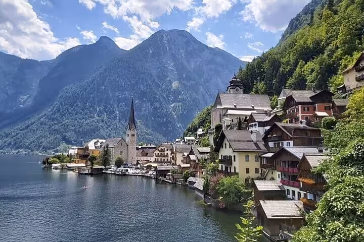 Hallstatt lakeside village and church spire, scenic stop on Salzburg to Vienna private transfer in Austria
