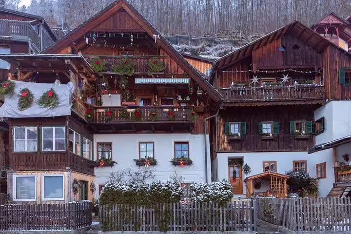 Traditional wooden houses in Hallstatt decorated for winter, perfect stop on a self-guided scavenger hunt tour