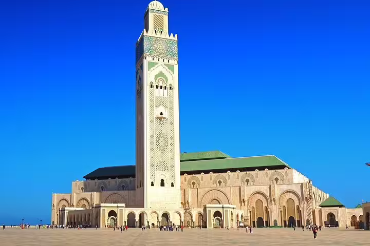 Hassan II Mosque in Casablanca under blue sky, highlight stop on Morocco 11 days tour from Marrakech