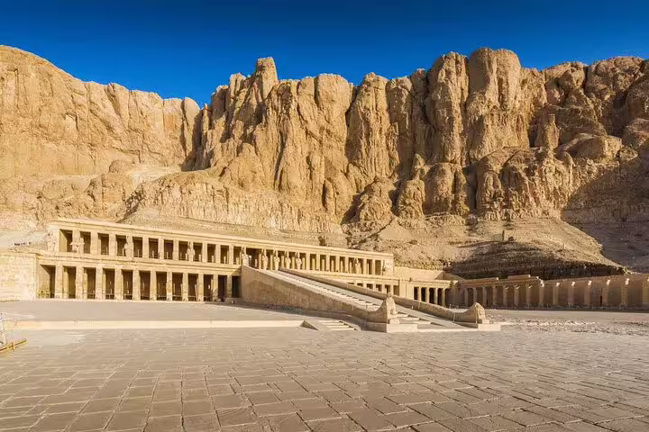 Hatshepsut Temple in Luxor framed by cliffs, highlight stop on Valley of the Kings day tour by bus from Hurghada