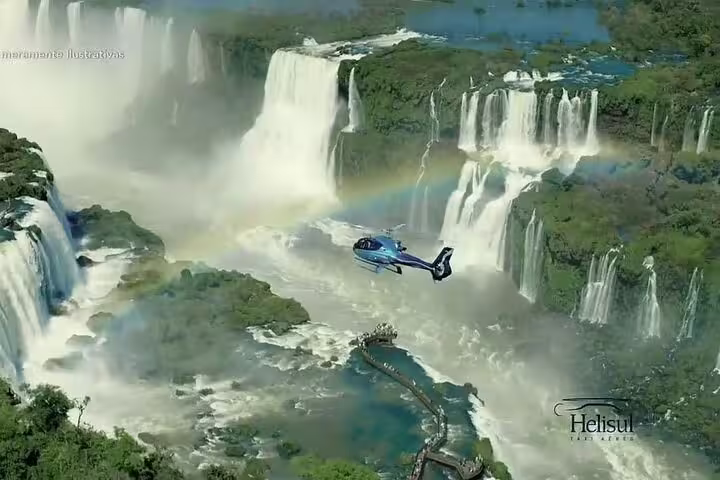 A helicopter soars above the stunning Iguazu Falls, capturing the breathtaking views of cascading waterfalls and rainbows.