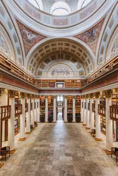 Stunning interior view of Helsinki's National Library showcasing ornate architecture and grand dome ceiling.