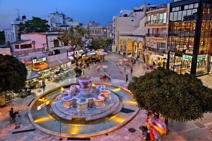 Heraklion Lions Square Morosini Fountain at night, lively city center visit on Knossos tour from Rethimno