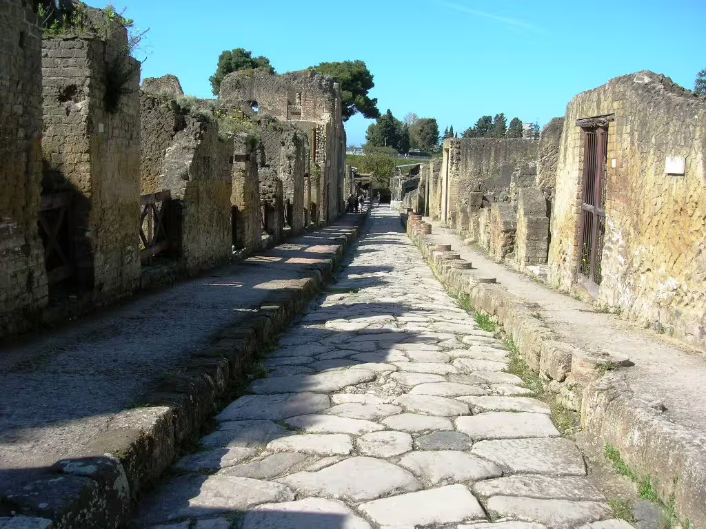 Ancient stone street and ruined houses in Herculaneum, a key stop on the Ercolano and Mt Vesuvius winery tour near Naples