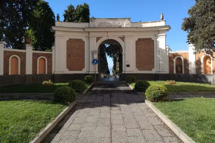 Entrance to Herculaneum archaeological site, inviting guests on a guided tour with lunch and included ticket.