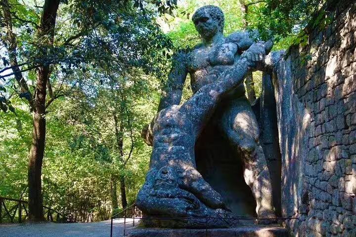 Massive Hercules statue battling a monster in Bomarzo Monster Park, a highlight of the Rome Calcata Bomarzo VIP tour
