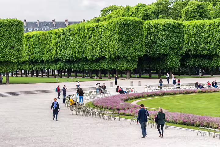 Visitors stroll through the serene, lush gardens of an undiscovered Paris quarter, showcasing hidden gems and tranquil escapes.
