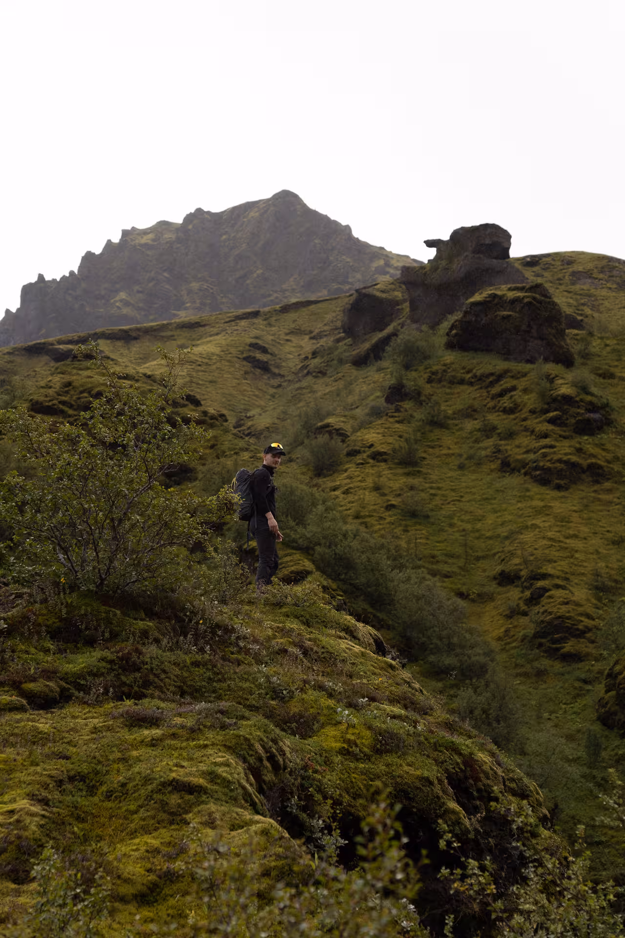 Hiker on mossy ridge in Þórsmörk valley during private off-road tour, Iceland highlands adventure