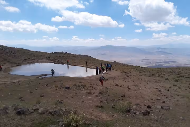 Hikers by a high-altitude crater lake near Mount Ararat on a private guided 3-day Dogubeyazit adventure tour