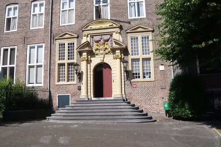 Historic Utrecht building entrance with ornate stonework and steps, landmark on a self-guided GPS tour route