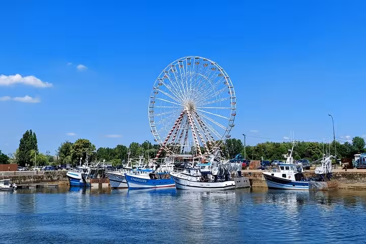 Honfleur harbor views with fishing boats and Ferris wheel, a scenic stop on the 2-hour e-bike tour
