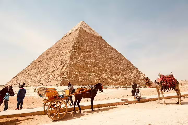 Horse carriage and camel by the Great Pyramid of Giza on a Memphis and Sakkara day trip from Cairo