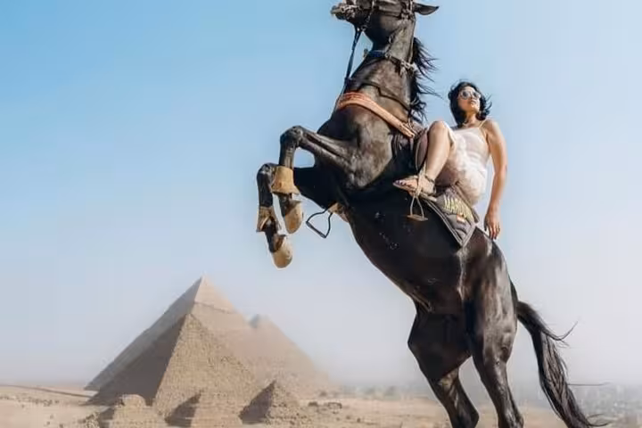 Horse jump photo at Giza Pyramids, traveler on rearing horse during half-day pyramids tour in Cairo